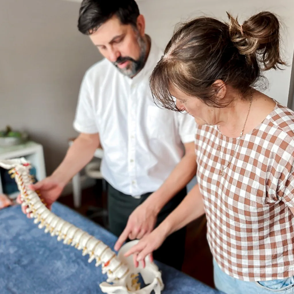 Osteopath and patient reviewing spinal alignment during chronic pain assessment in Warrnambool clinic 2