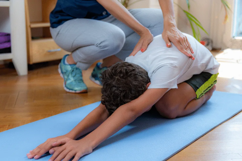 Osteopath for back pain Warrnambool: trainer assisting client in gentle lower back stretch to relieve lumbar tension.